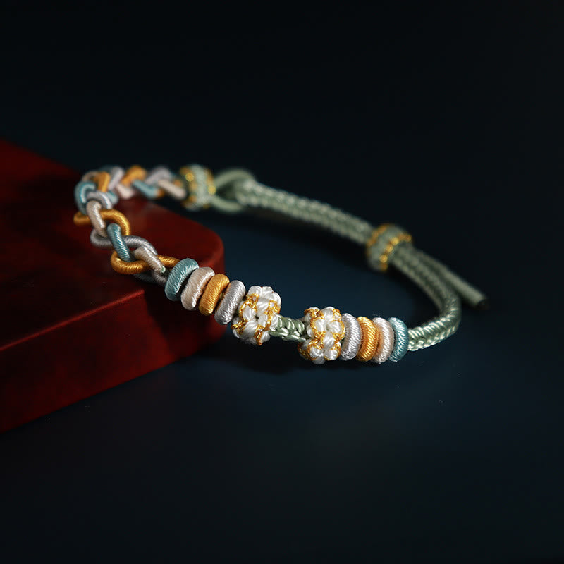 Pulsera de cuatro hilos con Buddha Stones y flor de durazno