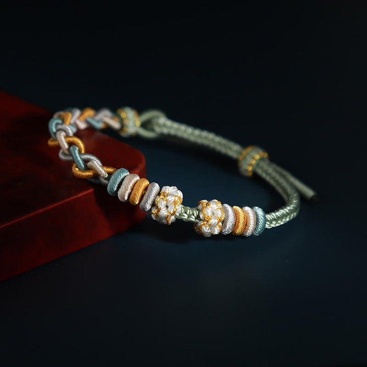 Pulsera de cuatro hilos con Buddha Stones y flor de durazno