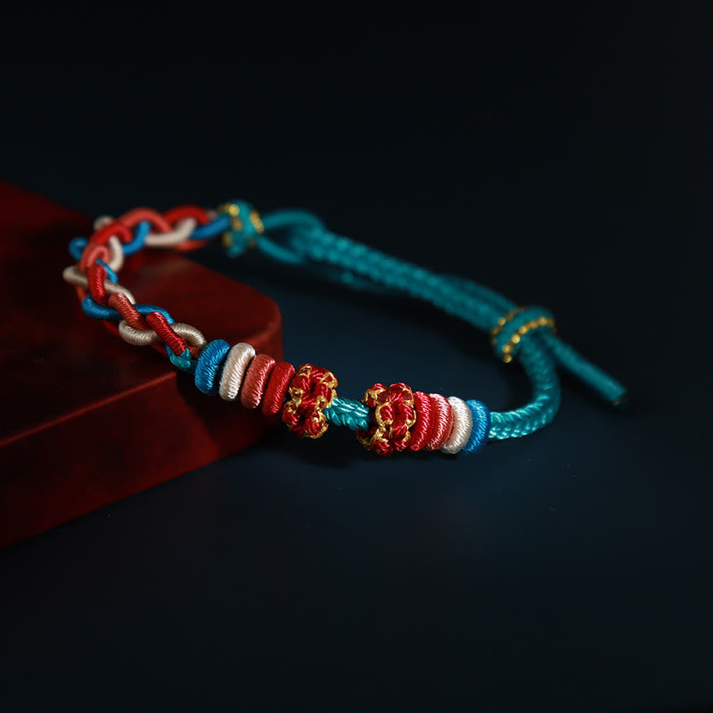 Pulsera de cuatro hilos con Buddha Stones y flor de durazno