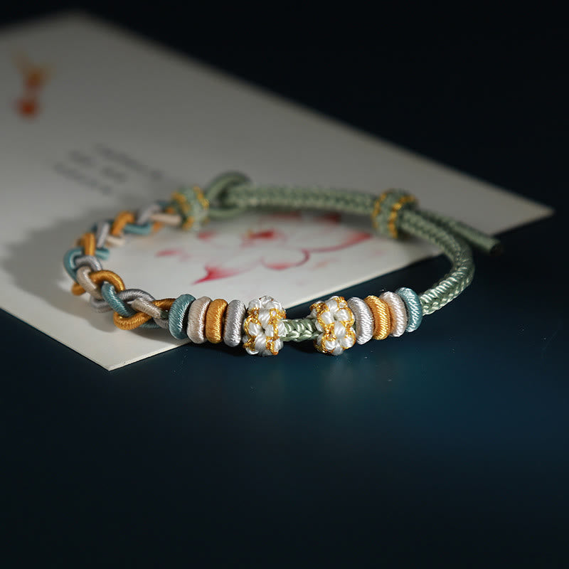 Pulsera de cuatro hilos con Buddha Stones y flor de durazno