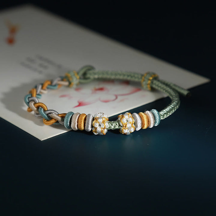 Pulsera de cuatro hilos con Buddha Stones y flor de durazno