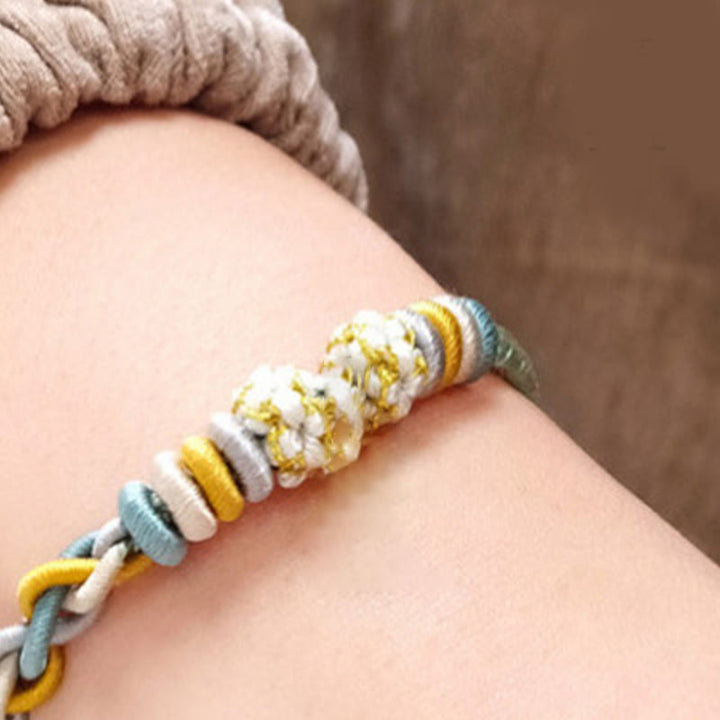 Pulsera de cuatro hilos con Buddha Stones y flor de durazno