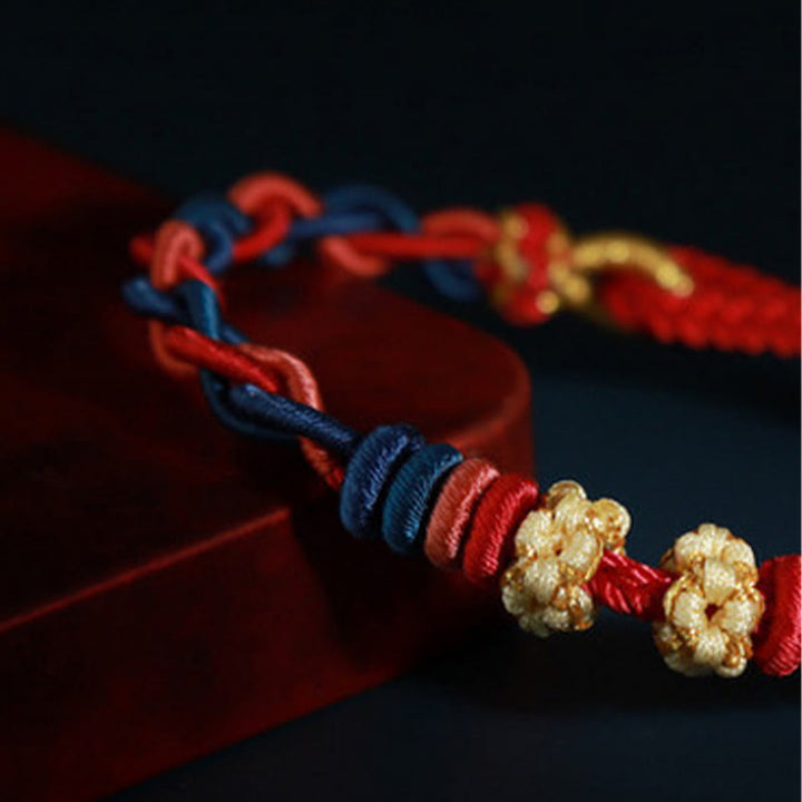 Pulsera de cuatro hilos con Buddha Stones y flor de durazno