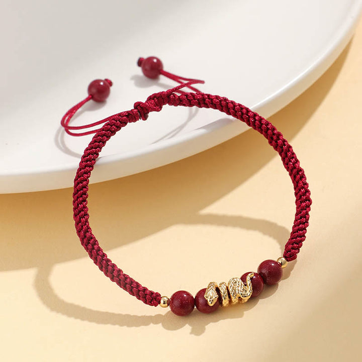 Pulsera trenzada de protección hecha a mano con Buddha Stones y cinabrio con hilo de serpiente