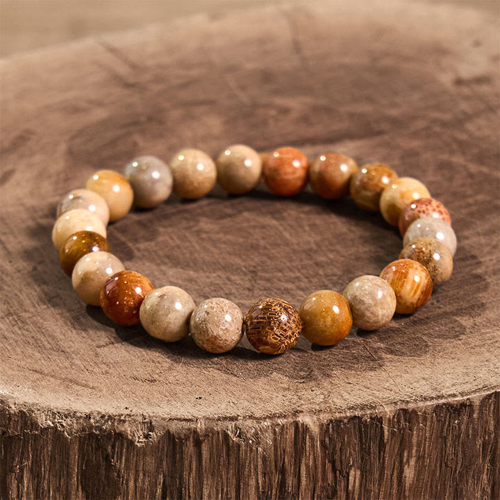 Pulsera de compasión de coral fósil con Buddha Stones