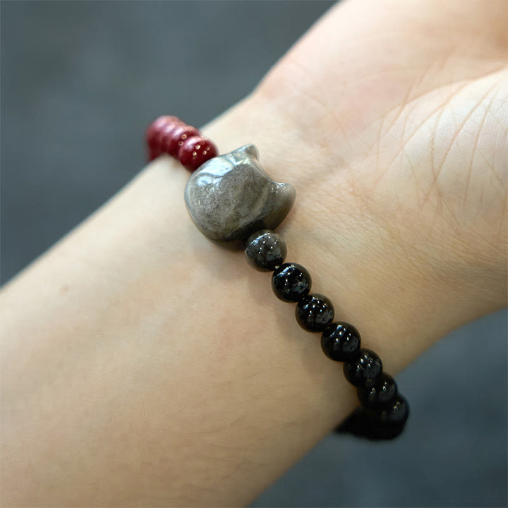Pulsera de obsidiana negra con Buddha Stones, cinabrio y plata con brillo de gato - image 4