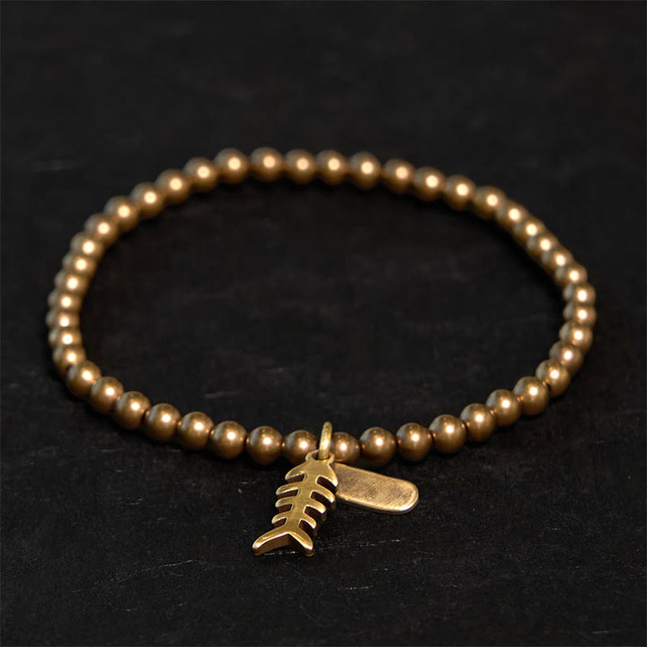 Pulsera curativa de espina de pescado de cobre con Buddha Stones