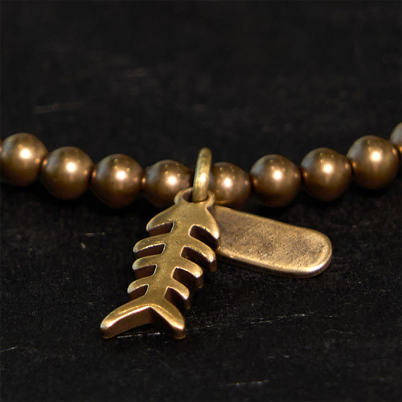 Pulsera curativa de espina de pescado de cobre con Buddha Stones