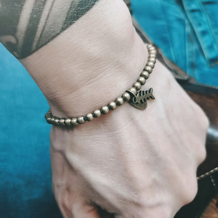 Pulsera curativa de espina de pescado de cobre con Buddha Stones
