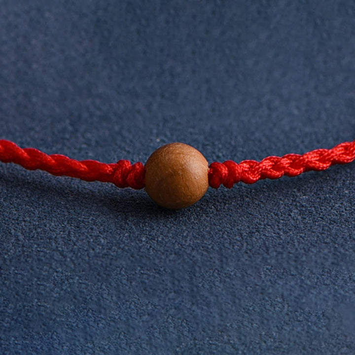 Pulsera trenzada con cuentas de madera de melocotón natural y Buddha Stones que alejan a los malos espíritus