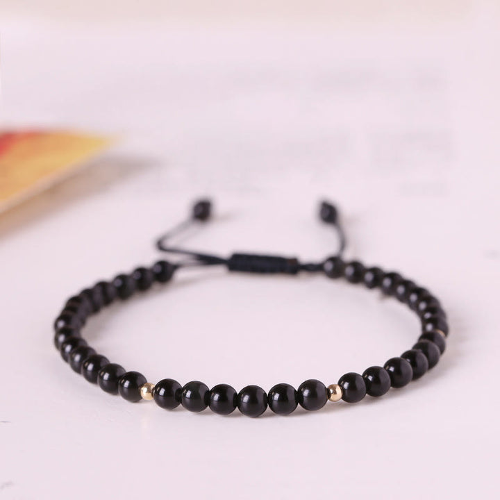 Pulsera de cuerda con cuentas pequeñas de obsidiana negra y Buddha Stones