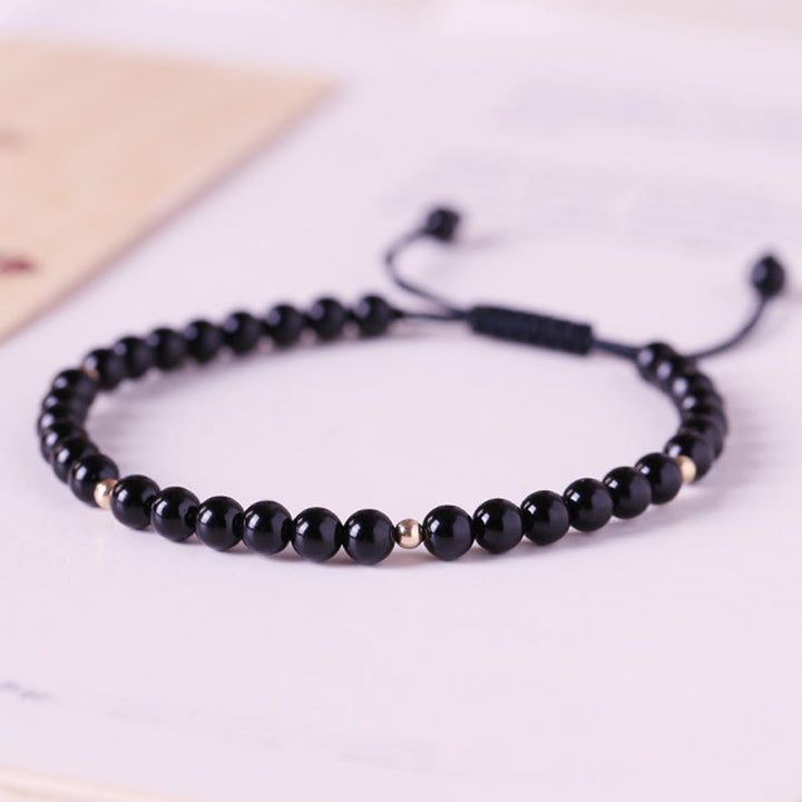 Pulsera de cuerda con cuentas pequeñas de obsidiana negra y Buddha Stones