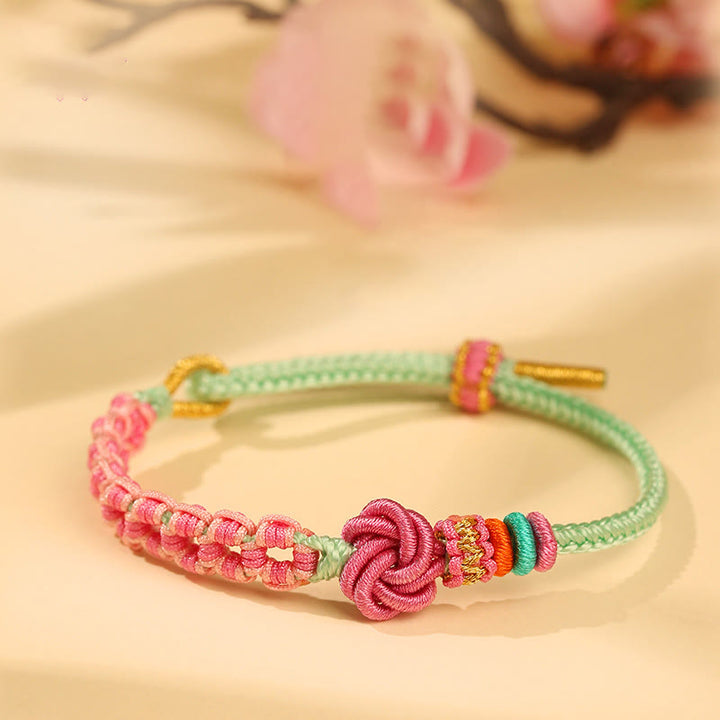 Pulsera trenzada con nudo de flor de durazno verde y rosa hecha a mano con Buddha Stones