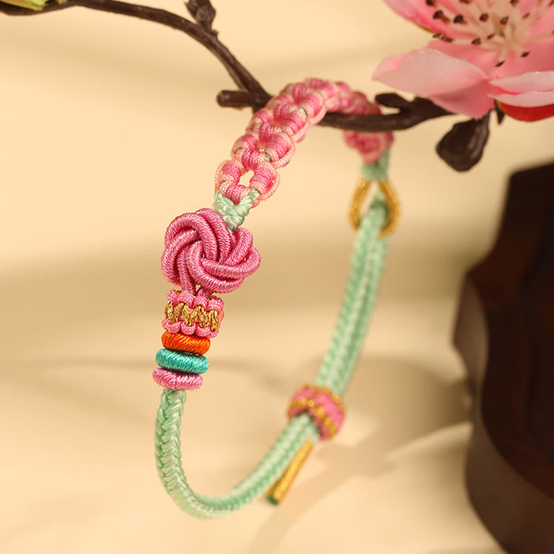 Pulsera trenzada con nudo de flor de durazno verde y rosa hecha a mano con Buddha Stones