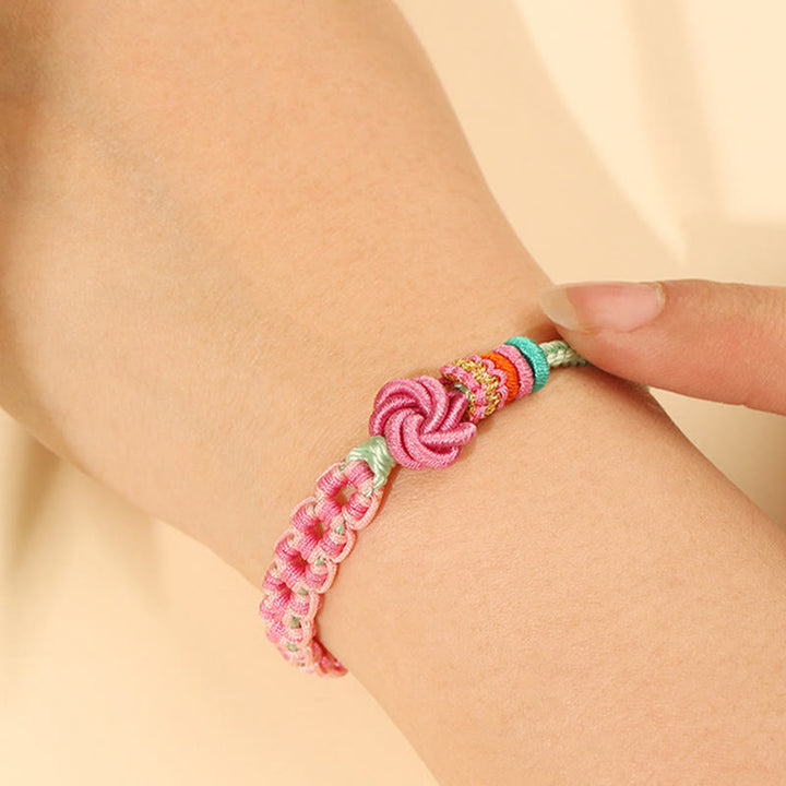 Pulsera trenzada con nudo de flor de durazno verde y rosa hecha a mano con Buddha Stones
