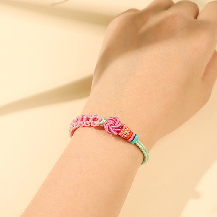 Pulsera trenzada con nudo de flor de durazno verde y rosa hecha a mano con Buddha Stones