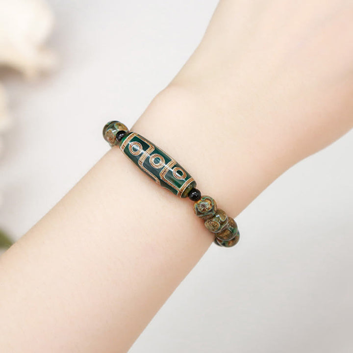 Pulsera de protección de energía con Buddha Stones de nueve ojos tibetanas de sándalo natural y ágata de ojo de gato blanca