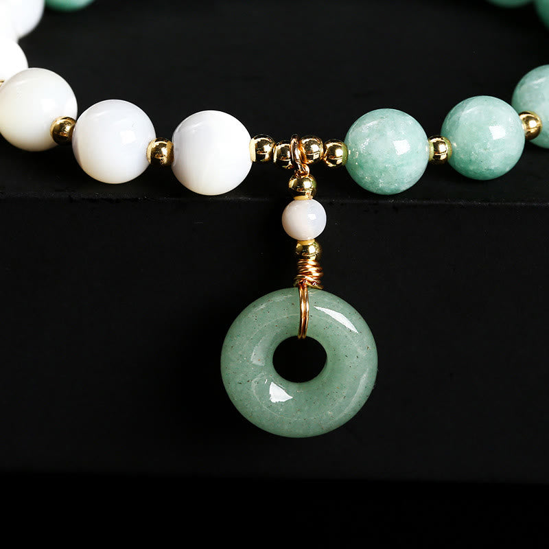 Pulsera con dije de paz y hebilla de caracol, herradura, trochus y Buddha Stones