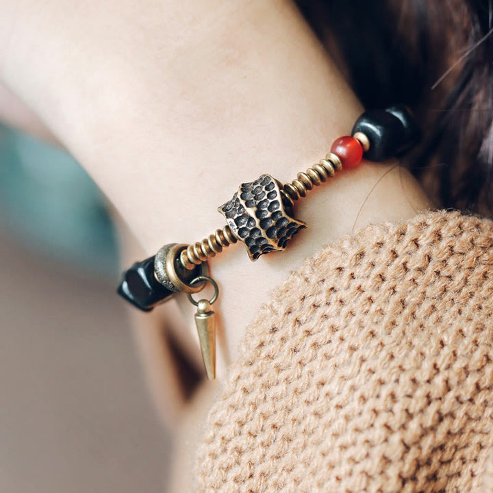 Pulsera de la paz con Buddha Stones, ébano, madera, cobre, latón y ágata roja