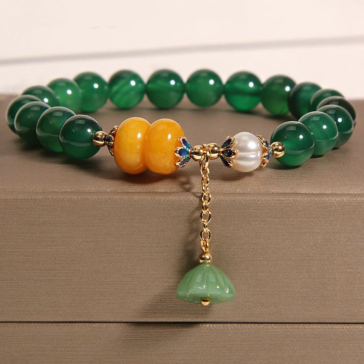 Pulsera de soporte con vaina de loto, ámbar, perla y ágata verde de Buddha Stones