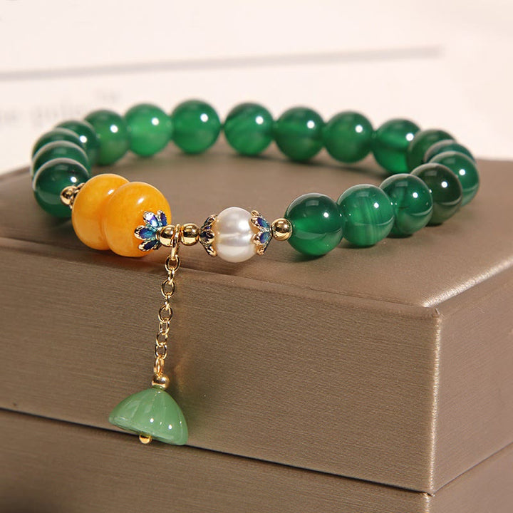 Pulsera de soporte con vaina de loto, ámbar, perla y ágata verde de Buddha Stones