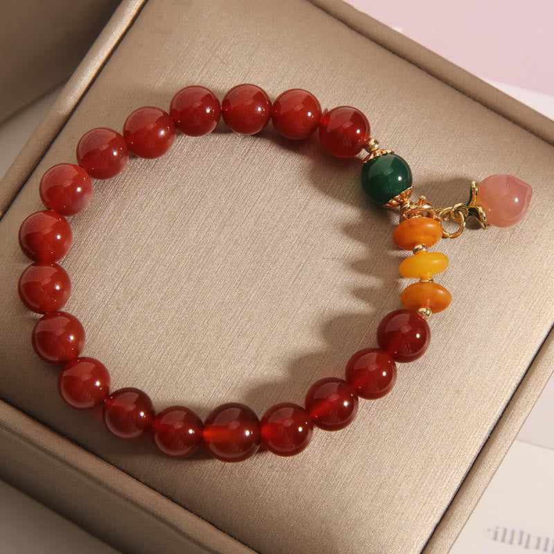 Pulsera de autoaceptación con dijes de melocotón, ámbar y ágata roja de Buddha Stones