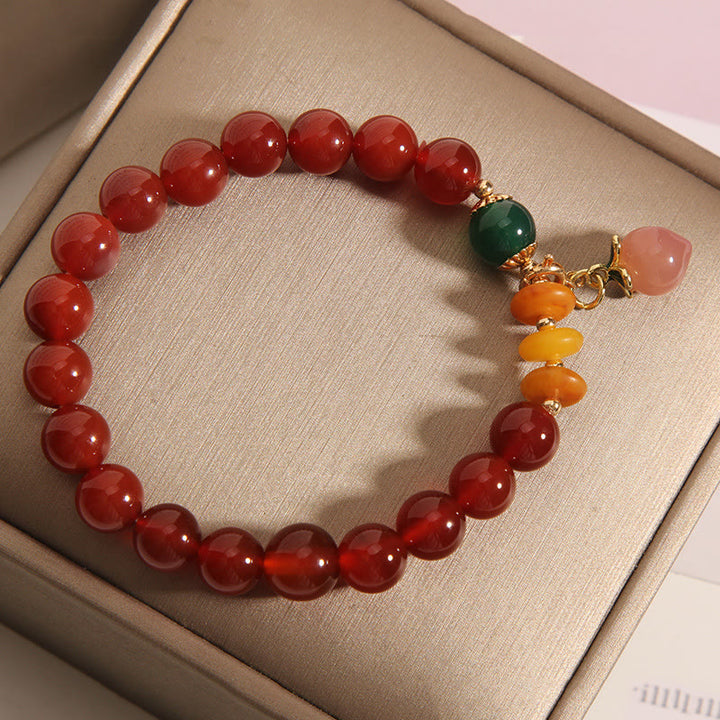 Pulsera de autoaceptación con dijes de melocotón, ámbar y ágata roja de Buddha Stones