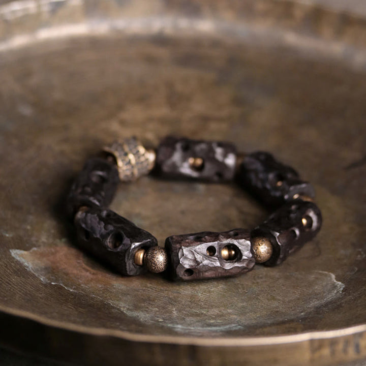 Pulsera de calma con Buddha Stones, madera de ébano, cobre y latón