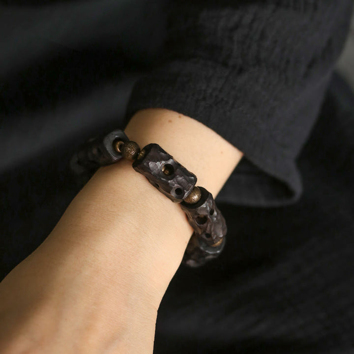 Pulsera de calma con Buddha Stones, madera de ébano, cobre y latón