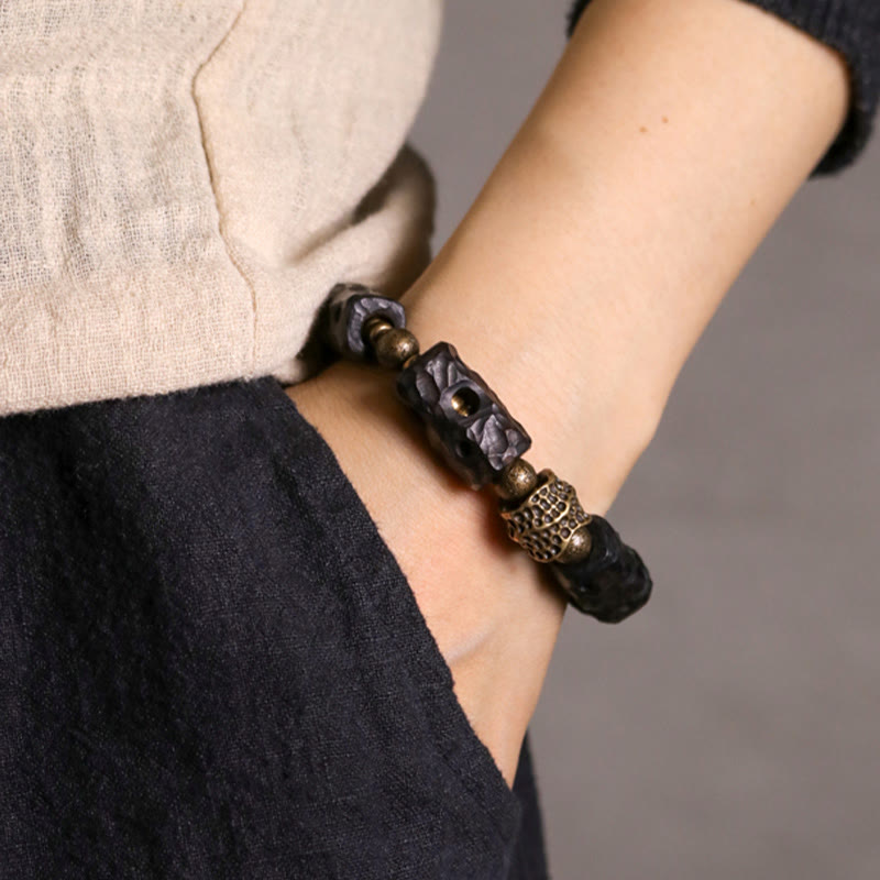 Pulsera de calma con Buddha Stones, madera de ébano, cobre y latón