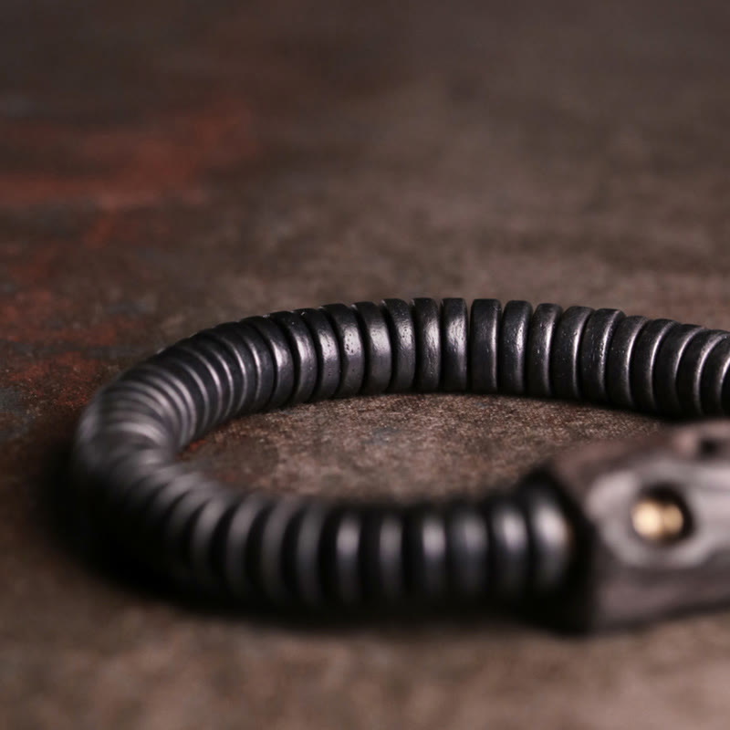 Pulsera de equilibrio perforada con Buddha Stones, madera de ébano, cobre y latón
