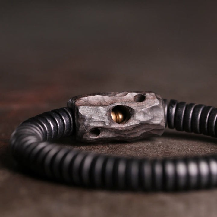 Pulsera de equilibrio perforada con Buddha Stones, madera de ébano, cobre y latón