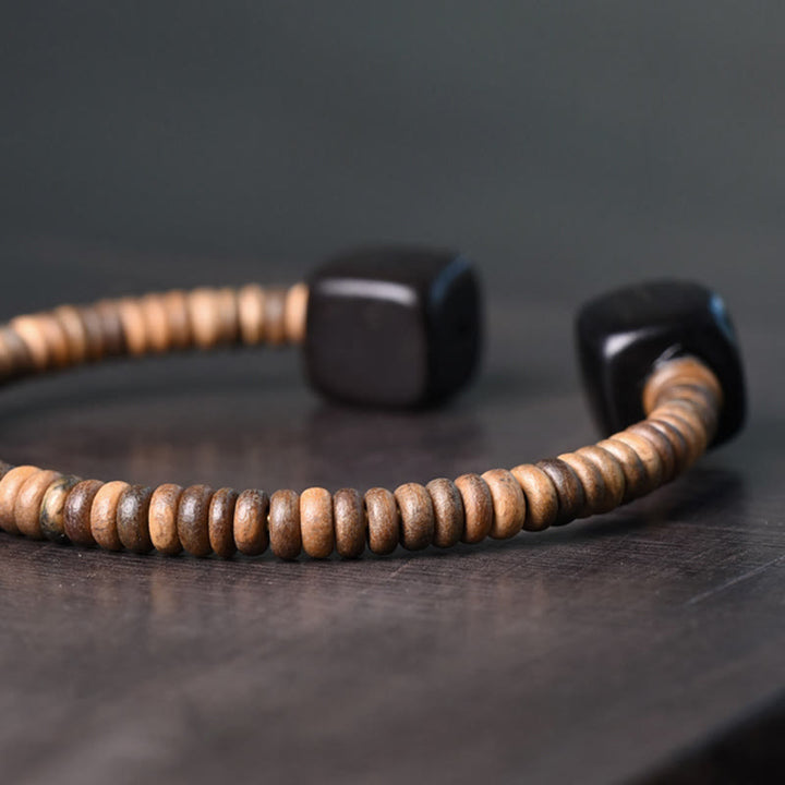 Pulsera de equilibrio con forma de cubo de sándalo verde y madera de ébano y Buddha Stones