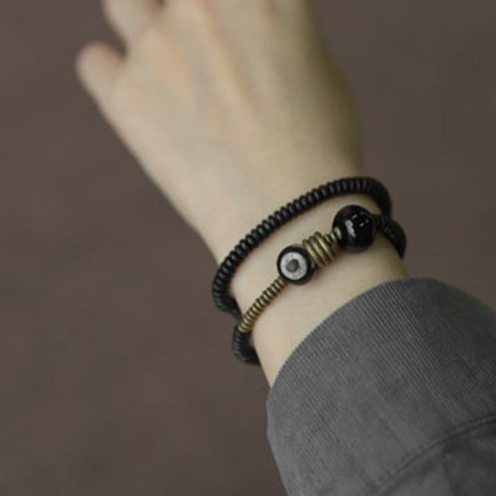 Pulsera de doble vuelta con cuentas Dzi de latón, cobre, sándalo verde, madera de ébano y Buddha Stones