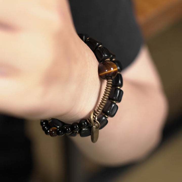 Pulsera de doble vuelta con Buddha Stones, madera de ébano, cobre, latón y ojo de tigre