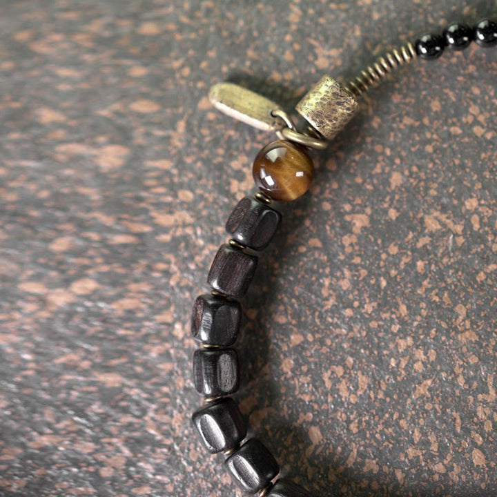 Pulsera de doble vuelta con Buddha Stones, madera de ébano, cobre, latón y ojo de tigre