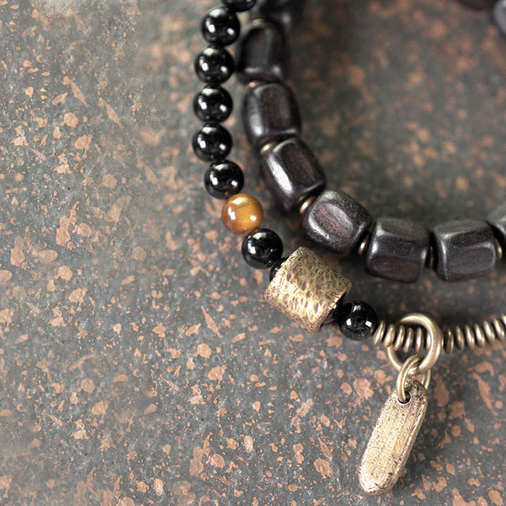Pulsera de doble vuelta con Buddha Stones, madera de ébano, cobre, latón y ojo de tigre