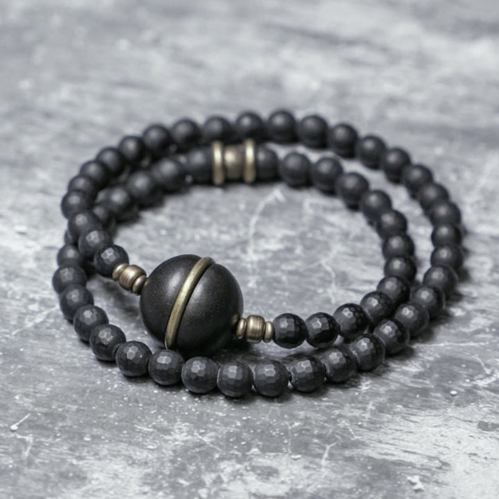 Pulsera protectora de doble envoltura con cuentas de ébano y ónix negro con superficie cortada esmerilada y Buddha Stones