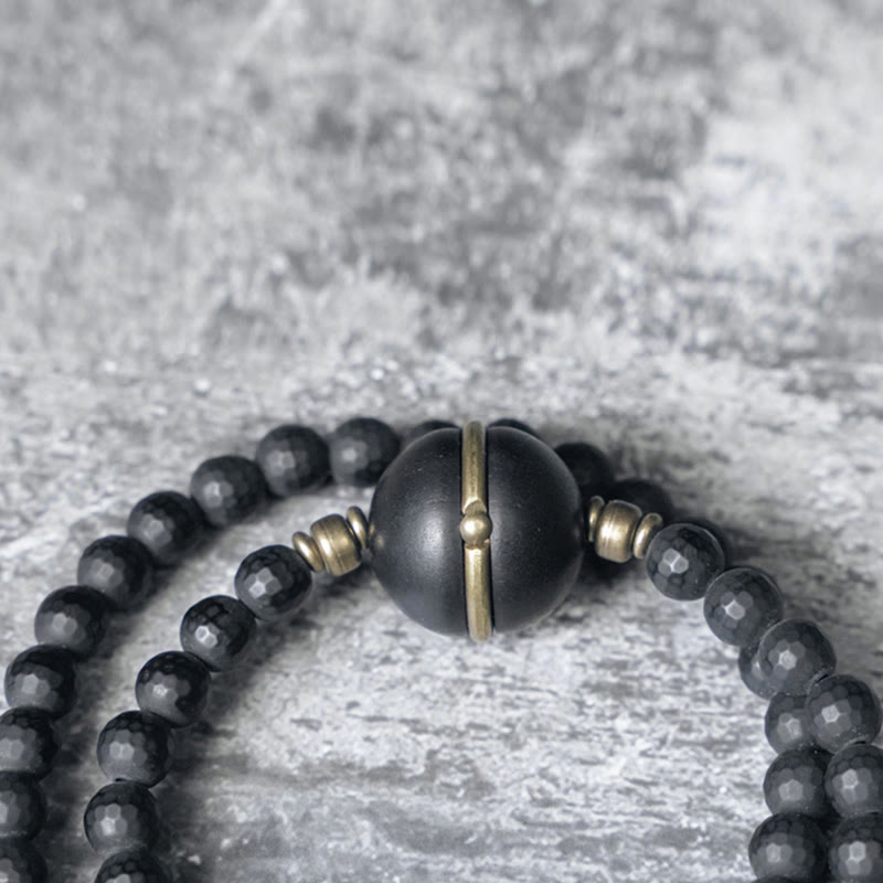 Pulsera protectora de doble envoltura con cuentas de ébano y ónix negro con superficie cortada esmerilada y Buddha Stones