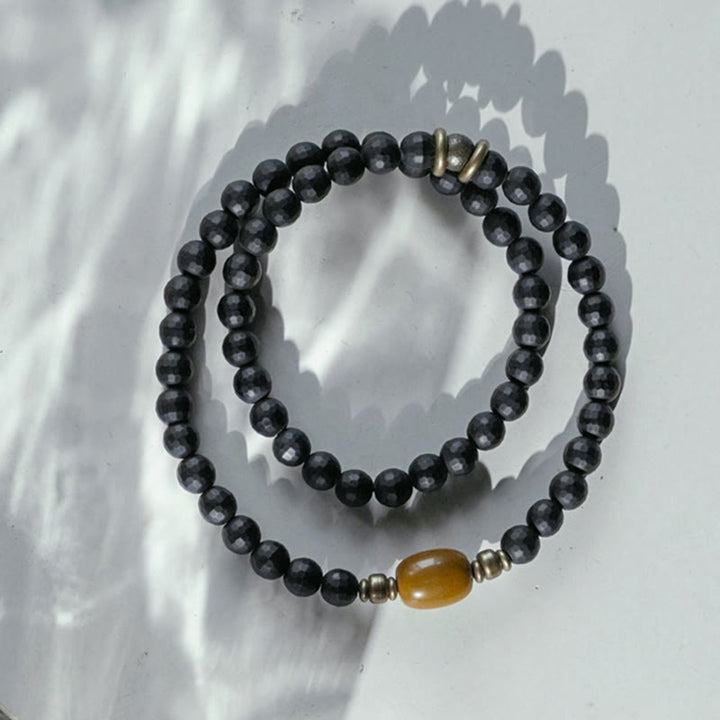 Pulsera protectora de doble envoltura con cuentas de topacio ónix negro y superficie cortada esmerilada con Buddha Stones