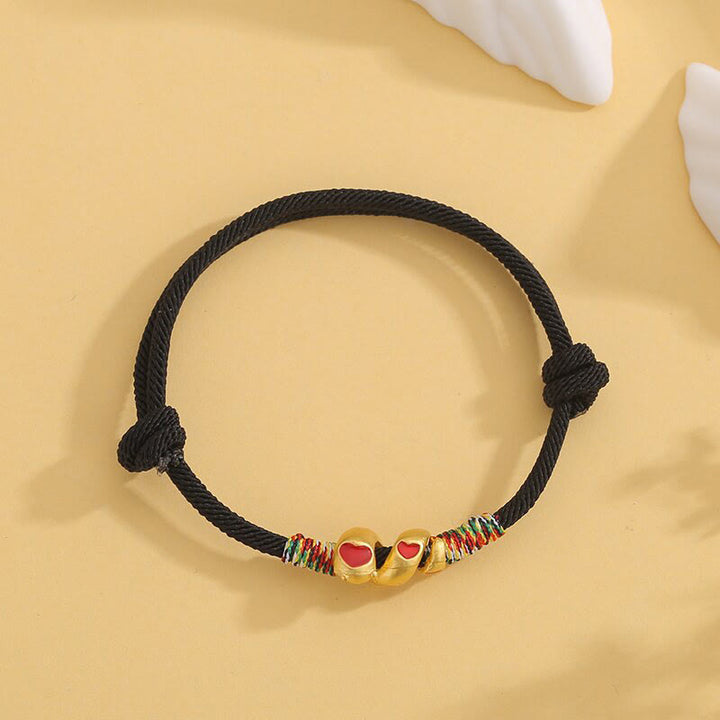 Pulsera trenzada de protección del año de la serpiente con hilo rojo y aleación de cobre y Buddha Stones
