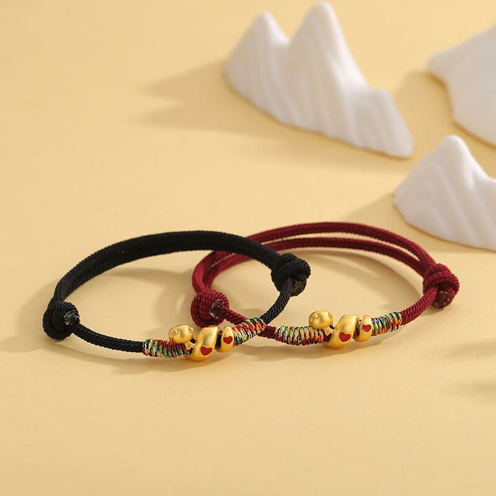 Pulsera trenzada de protección del año de la serpiente con hilo rojo y aleación de cobre y Buddha Stones