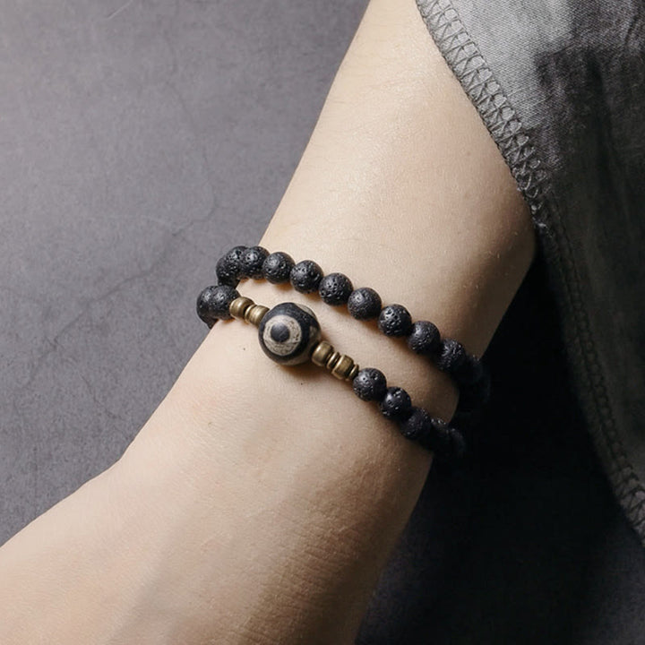 Pulsera curativa de doble vuelta con cuentas de latón y cobre de tres ojos de piedra de lava vintage de Buddha Stones