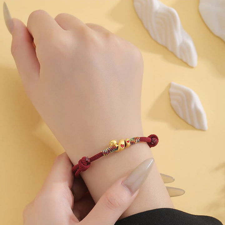 Pulsera trenzada de protección del año de la serpiente con hilo rojo y aleación de cobre y Buddha Stones