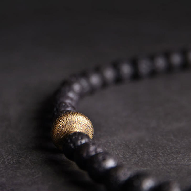 Pulsera curativa de doble vuelta con cuentas de latón y cobre de tres ojos de piedra de lava vintage de Buddha Stones