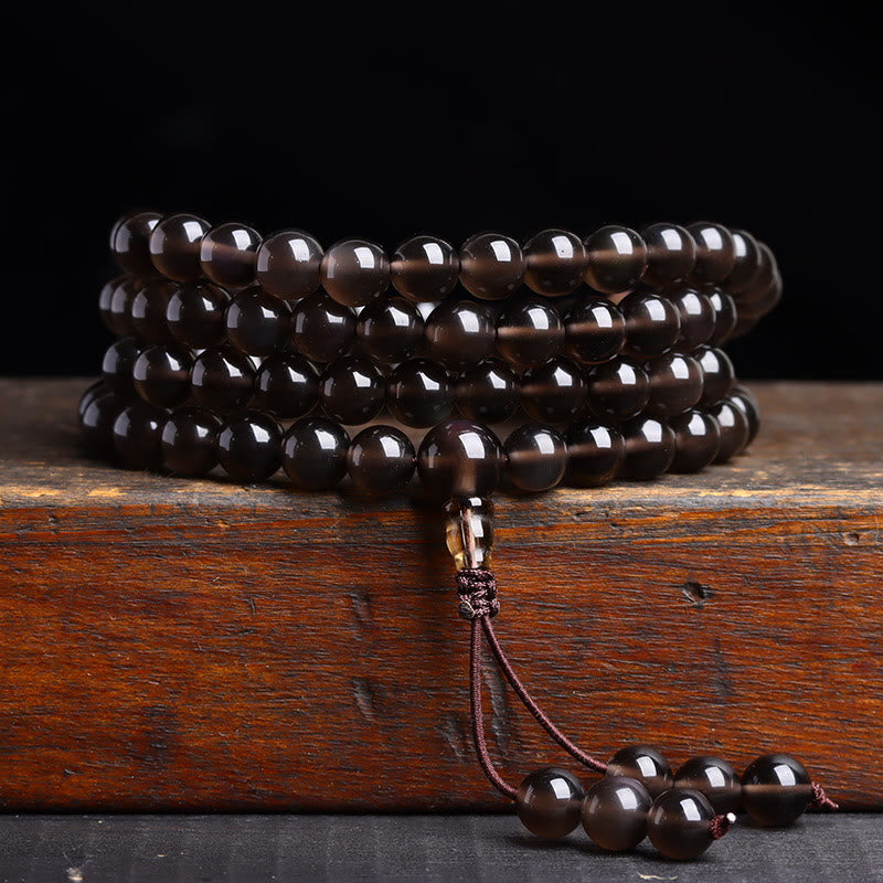 Pulsera de obsidiana negra con 108 cuentas de mala y Buddha Stones