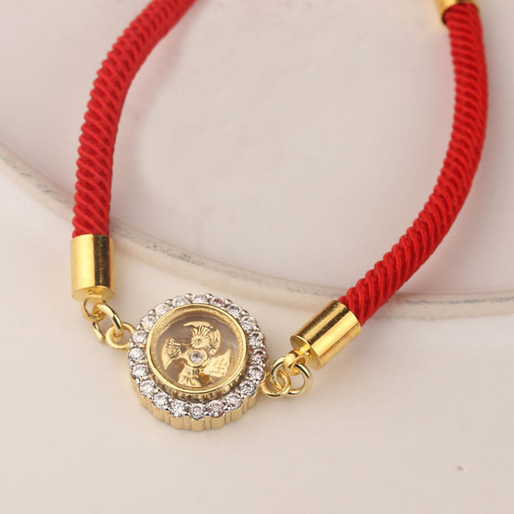 Pulsera trenzada con protección de Qi Feng Sheng Shui con molino de viento giratorio de cobre y latón con hilo rojo y Buddha Stones
