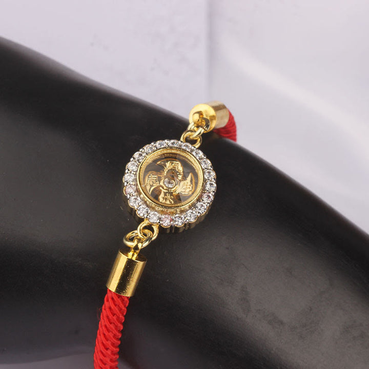 Pulsera trenzada con protección de Qi Feng Sheng Shui con molino de viento giratorio de cobre y latón con hilo rojo y Buddha Stones