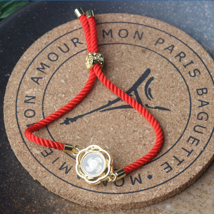 Pulsera trenzada con protección de Qi y Feng Sheng Shui con molino de viento de cobre y latón con hilo rojo ciruela giratorio y Buddha Stones