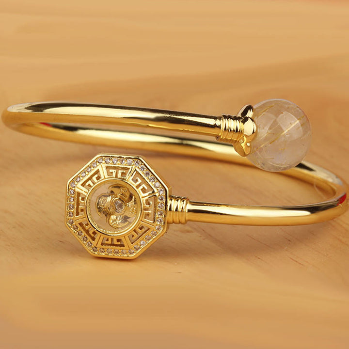Pulsera brazalete de coraje de Feng Sheng Shui Qi con molino de viento giratorio de cobre y latón con Buddha Stones y cuarzo rutilado